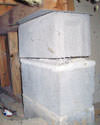 Concrete crawl space support posts in Westport that are showing signs of failure as they sink into the earth.