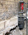 A completed installation of foundation push piers lifting a foundation in Sharbot Lake