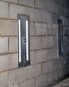 an inside view of foundation wall anchors installed along a basement wall to brace and repair the structure in Matawatchan