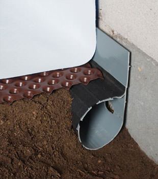 Closeup of a crawl space drainage system installed in Frankford