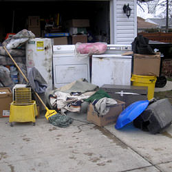 Soaked, wet personal items sitting in a driveway, including a washer and dryer in Birds Creek.