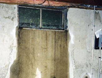 Water pouring out from a basement window in Tweed